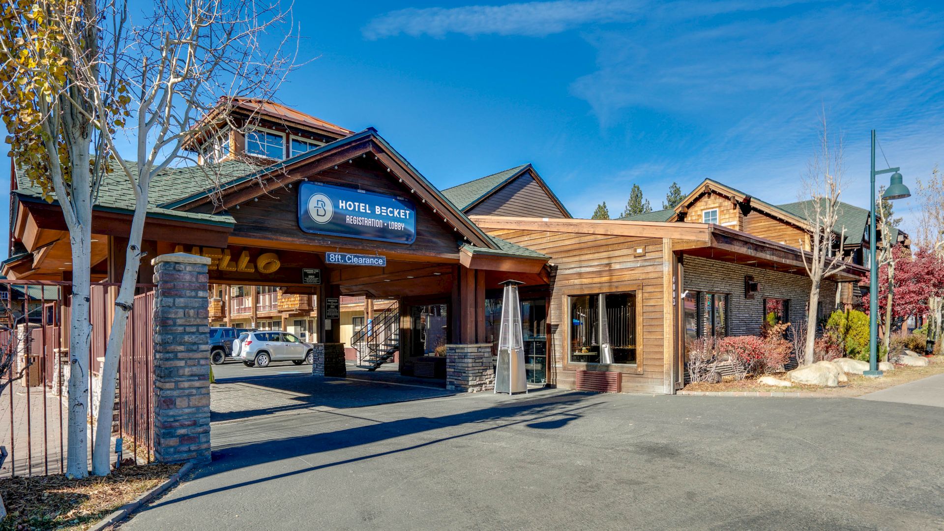 The image shows the exterior of Hotel Ruby, featuring a wooden facade and an entrance with a sign displaying the hotel's name.